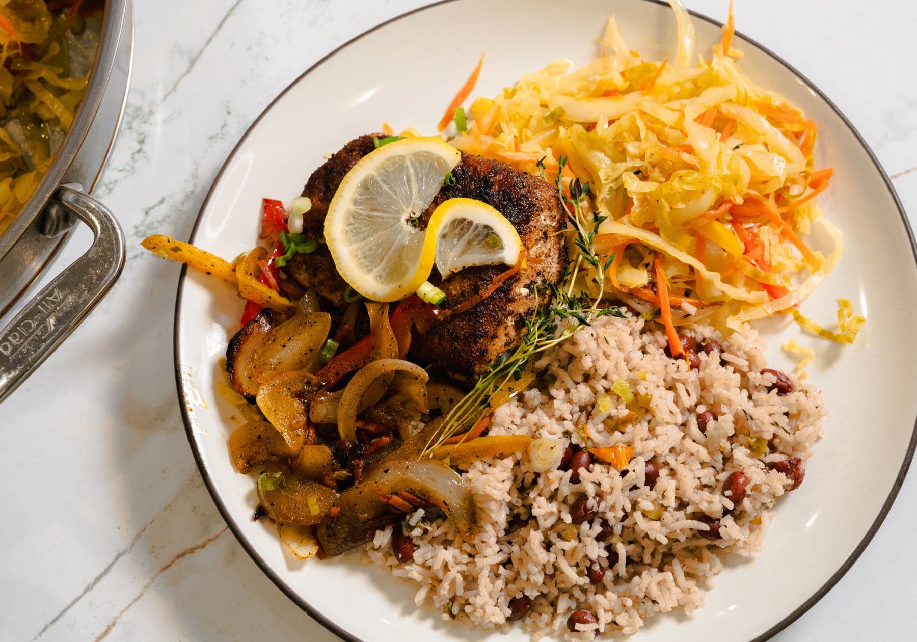 Escovitch fish with rice and peas and a cabbage slaw.
